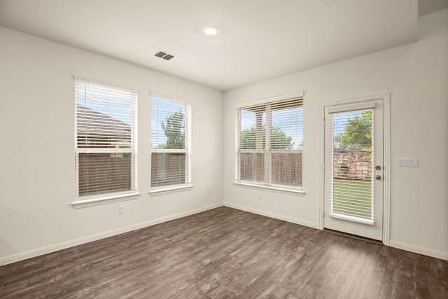 spare room with dark hardwood / wood-style flooring