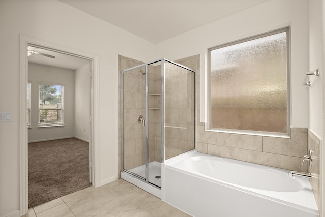 bathroom featuring shower with separate bathtub, ceiling fan, and tile patterned flooring