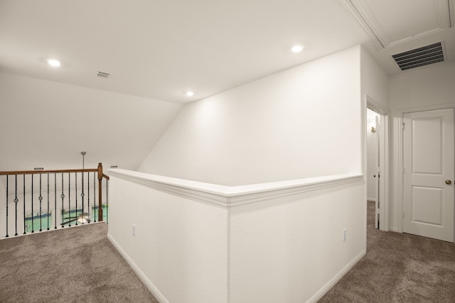 hall featuring vaulted ceiling and carpet