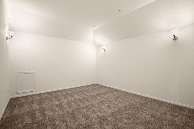 empty room with dark colored carpet