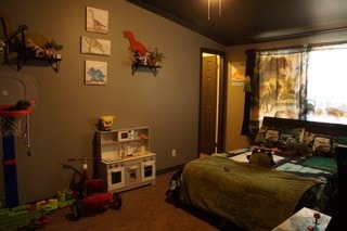 carpeted bedroom with ornamental molding