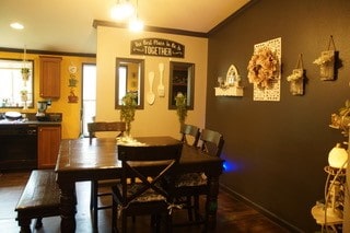 dining area featuring crown molding and dark wood-type flooring