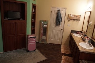 bathroom featuring wood-type flooring and dual vanity