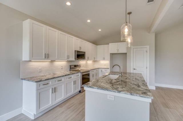 kitchen with a kitchen island with sink, hanging light fixtures, sink, appliances with stainless steel finishes, and white cabinetry