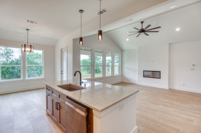 kitchen featuring sink, light stone counters, lofted ceiling with beams, stainless steel dishwasher, and a kitchen island with sink