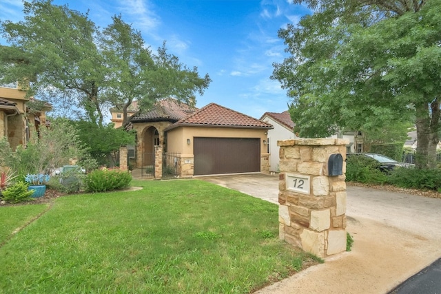 mediterranean / spanish-style house with a garage and a front yard