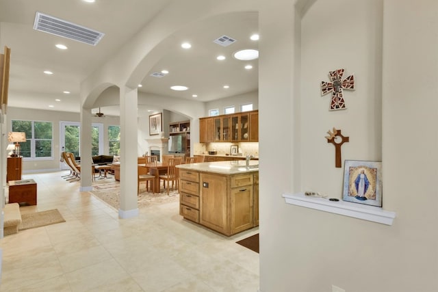 kitchen with sink, tasteful backsplash, and light tile floors