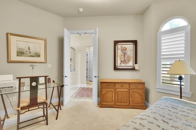 bedroom featuring light carpet