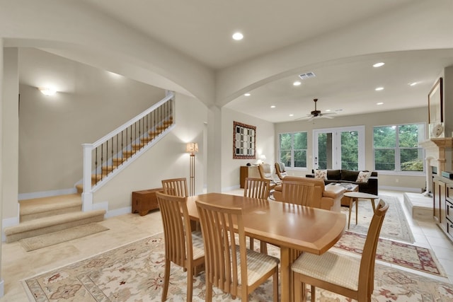 tiled dining room with french doors and ceiling fan