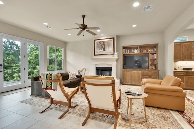 tiled living room featuring ceiling fan