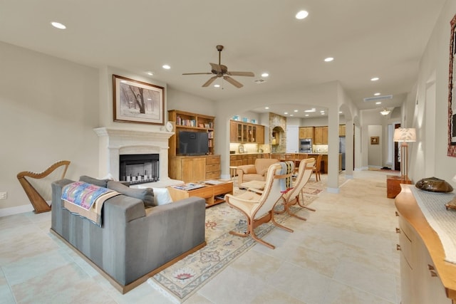 living room featuring ceiling fan and light tile flooring