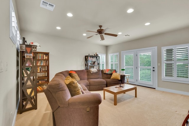 carpeted living room featuring ceiling fan