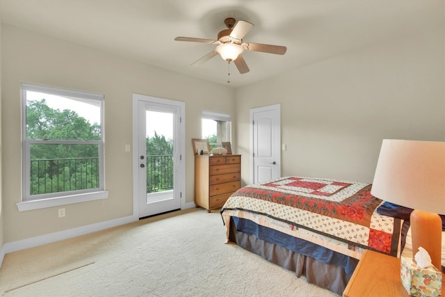 bedroom with carpet, access to exterior, multiple windows, and ceiling fan