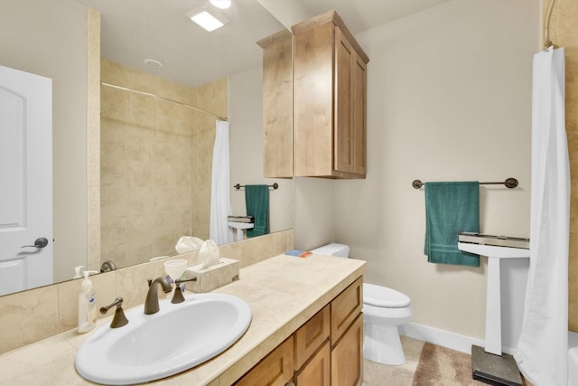 bathroom featuring tile floors, toilet, and vanity