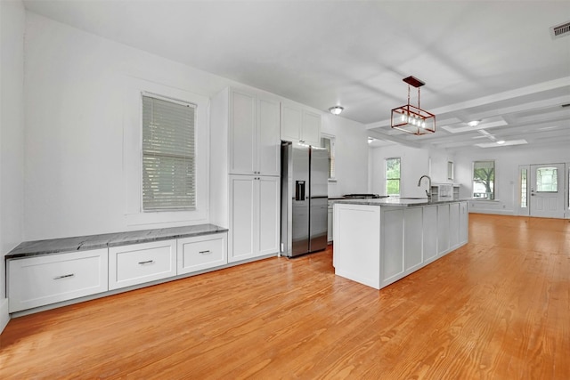 kitchen with stainless steel refrigerator with ice dispenser, coffered ceiling, light hardwood / wood-style flooring, and white cabinets