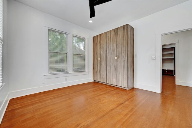 unfurnished bedroom with a closet, ceiling fan, and light hardwood / wood-style floors