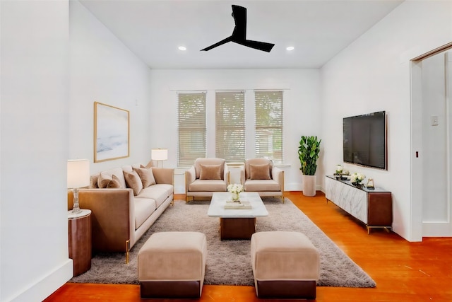 living room featuring ceiling fan and hardwood / wood-style flooring