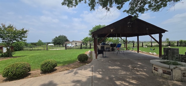 surrounding community featuring a patio area, a gazebo, and a lawn