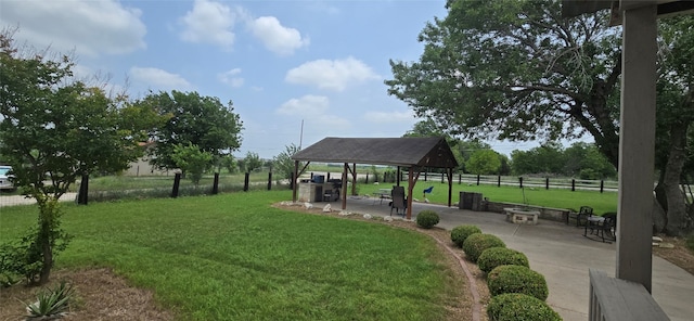 view of home's community featuring a patio area, a lawn, and a gazebo