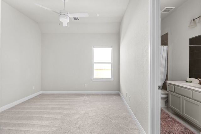 interior space featuring toilet, baseboards, visible vents, and vanity