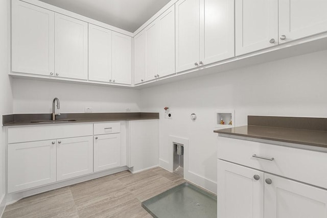 washroom featuring hookup for a washing machine, cabinet space, a sink, and gas dryer hookup