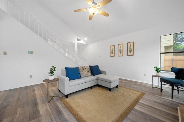 living room with ceiling fan, wood-type flooring, and high vaulted ceiling