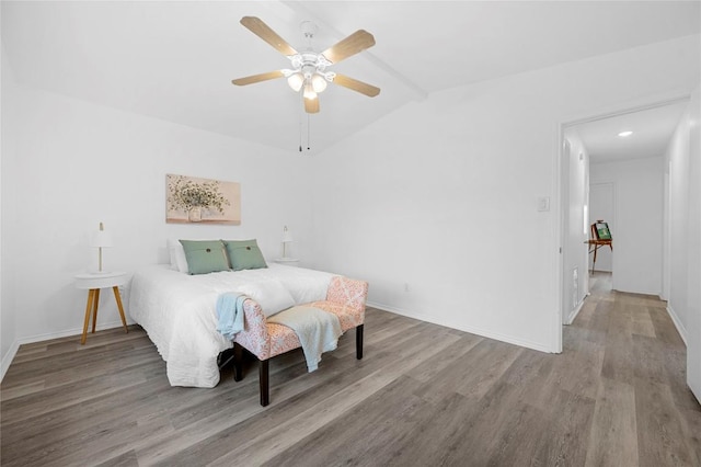 bedroom featuring ceiling fan, lofted ceiling with beams, and hardwood / wood-style flooring