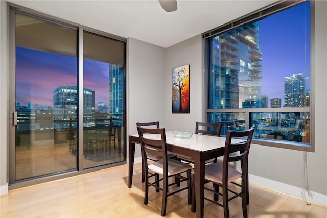 dining room with hardwood / wood-style flooring and ceiling fan