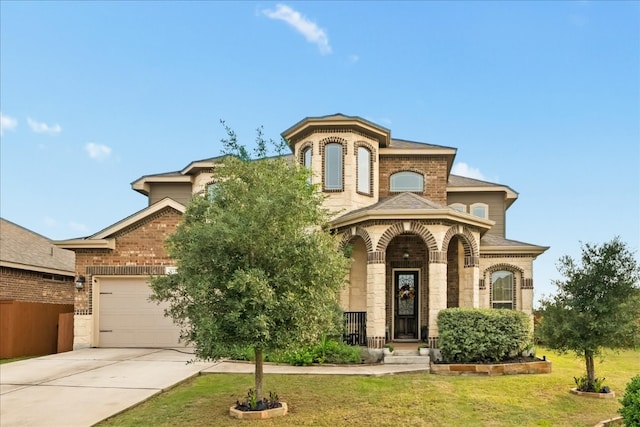 view of front of property with a front lawn and a garage