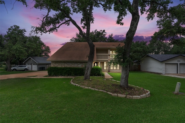 view of front of property featuring a garage and a yard