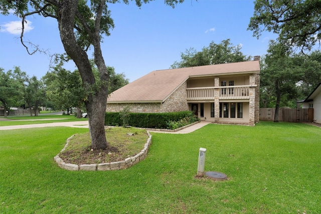 exterior space featuring a lawn and a balcony