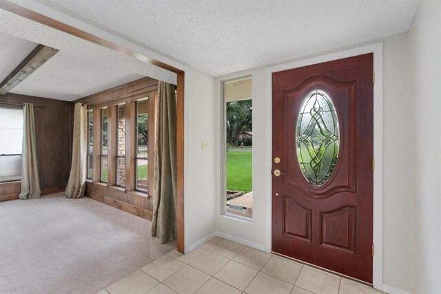 entrance foyer featuring a textured ceiling and light tile patterned flooring