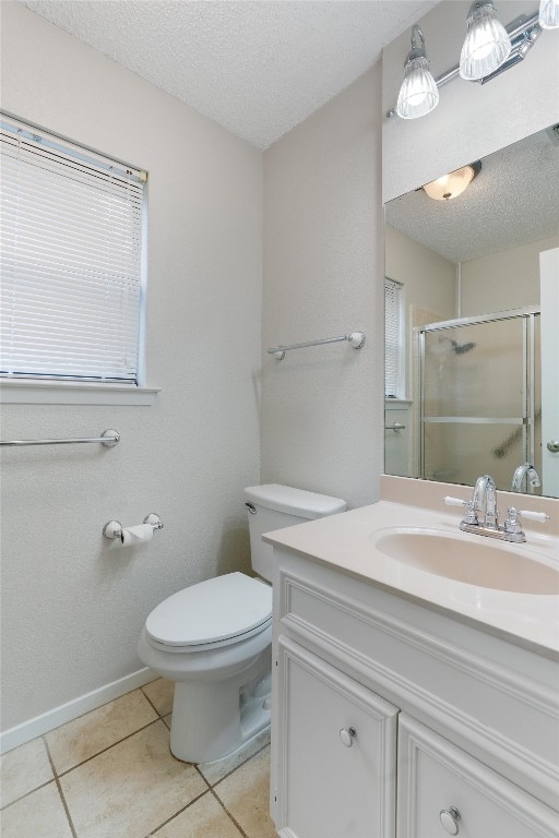 bathroom featuring tile patterned floors, a textured ceiling, vanity, and toilet