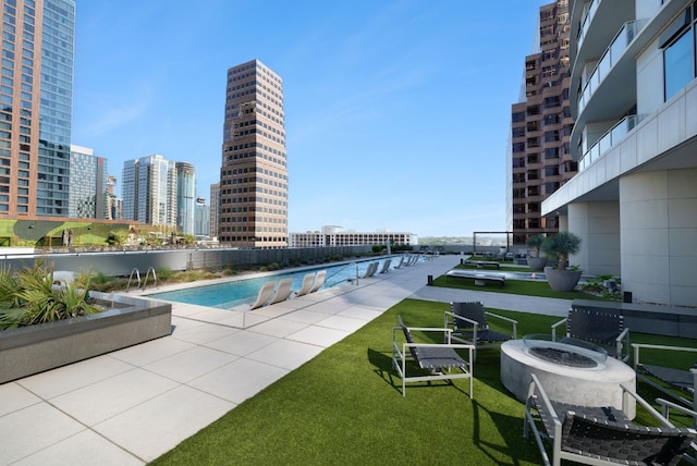 view of swimming pool featuring a lawn and a patio area