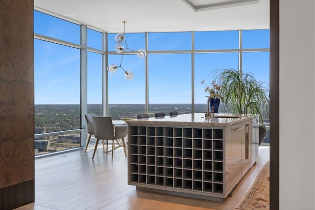 interior space with a water view, sink, a chandelier, and a wealth of natural light