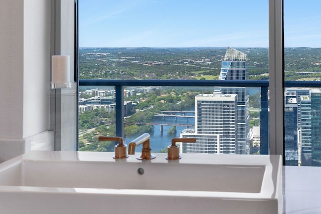 balcony featuring sink and a water view