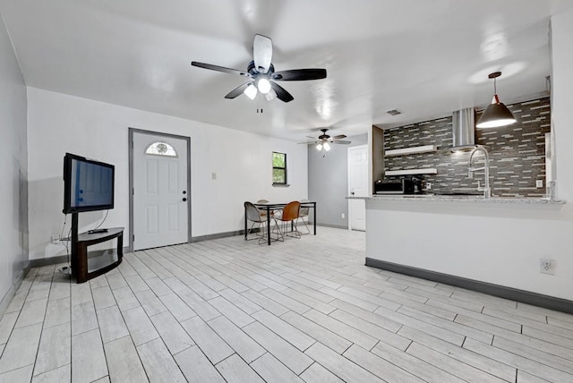 interior space with light hardwood / wood-style floors and ceiling fan