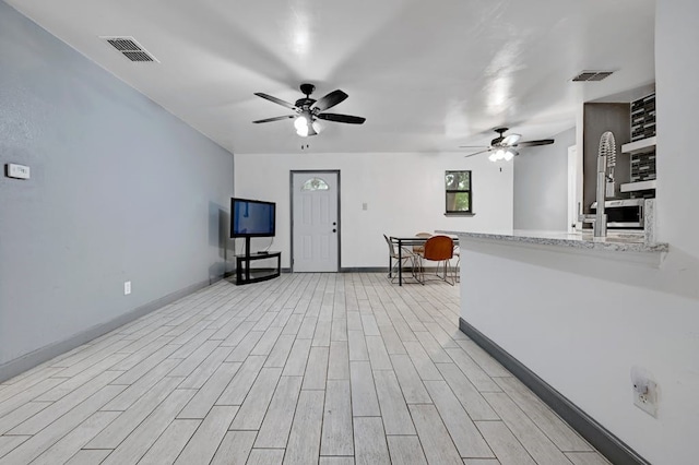 interior space with light hardwood / wood-style floors and ceiling fan