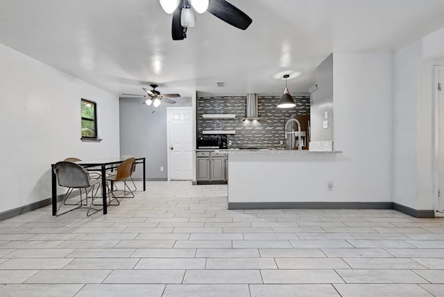 kitchen featuring tasteful backsplash, extractor fan, ceiling fan, and light tile floors