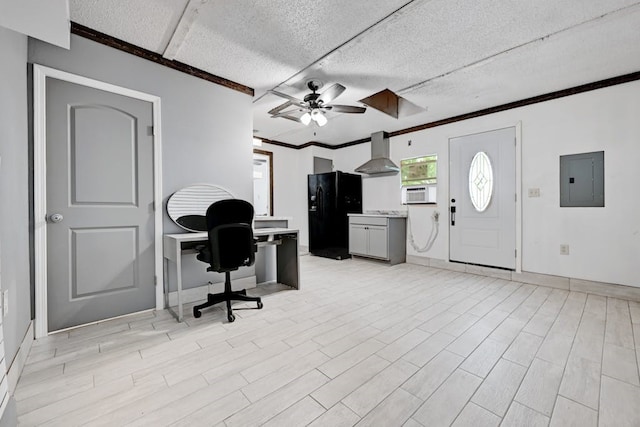 home office featuring a textured ceiling, ceiling fan, and light hardwood / wood-style floors