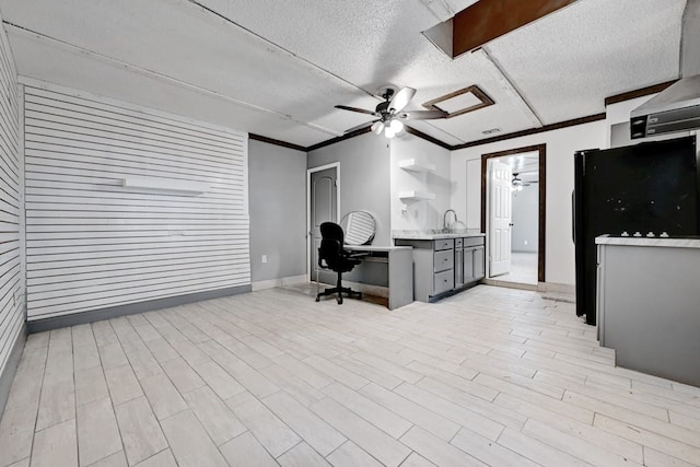 home office featuring a textured ceiling, ceiling fan, and light hardwood / wood-style floors