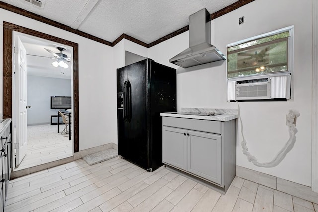 kitchen with ceiling fan, light tile flooring, black appliances, a textured ceiling, and wall chimney range hood