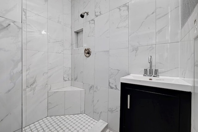 bathroom with vanity and a tile shower