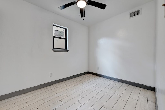 spare room featuring ceiling fan and light wood-type flooring