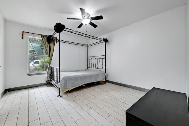 unfurnished bedroom with ceiling fan and light wood-type flooring