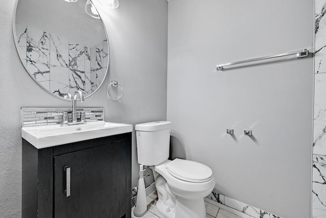 bathroom with vanity, toilet, and tile flooring