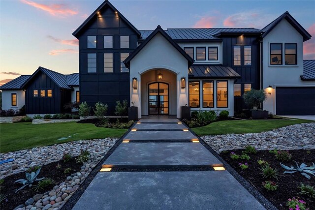 view of front of home with a yard and a garage