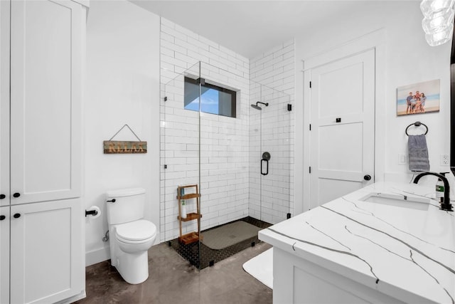 bathroom featuring concrete flooring, a stall shower, vanity, and toilet