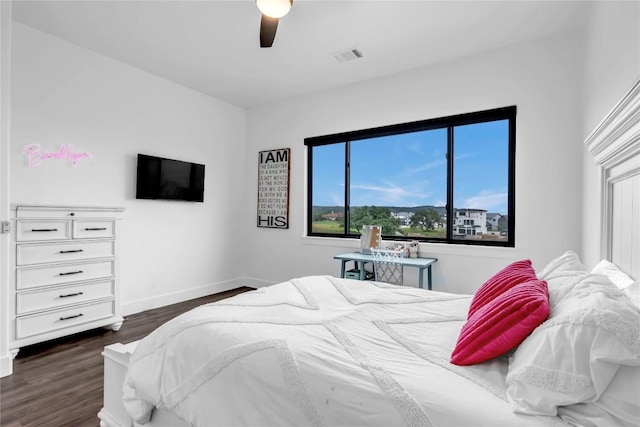 bedroom featuring baseboards, visible vents, ceiling fan, and dark wood-type flooring