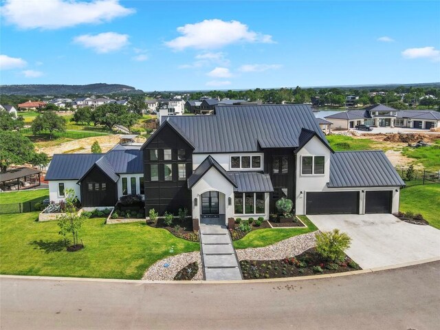 modern farmhouse style home featuring a garage and a front yard